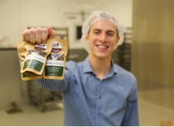 young man holding bags of food products